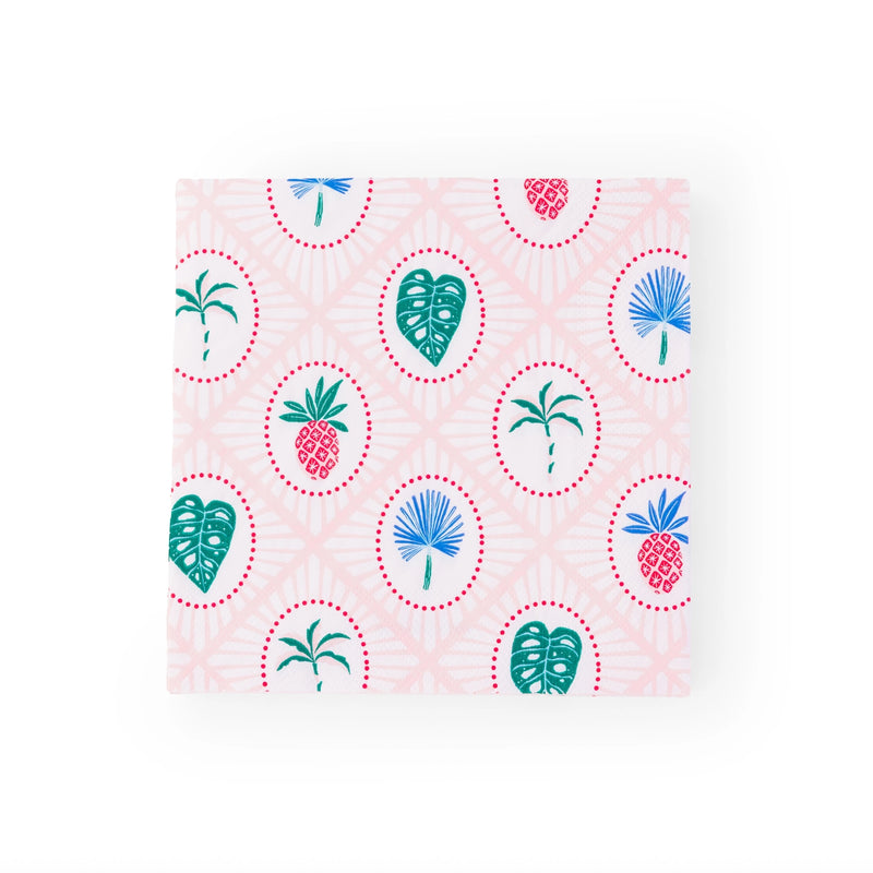Single folded napkin showing repeating icons of pineapples, monstera leaves, and blue palm fronds on lattice background.