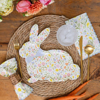 Easter place setting featuring floral bunny plate, gold utensils, and garden decor
