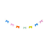 A colorful banner of layered felt bows in pink, blue, yellow, and mint green, ideal for spring party decorations.