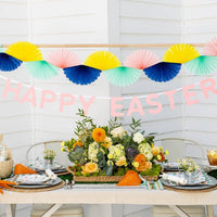 Pastel Easter garland hanging above spring party table with decorations