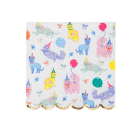 Top-down view of a square white paper napkin featuring pastel watercolor cats in party hats and a gold foil scalloped edge.