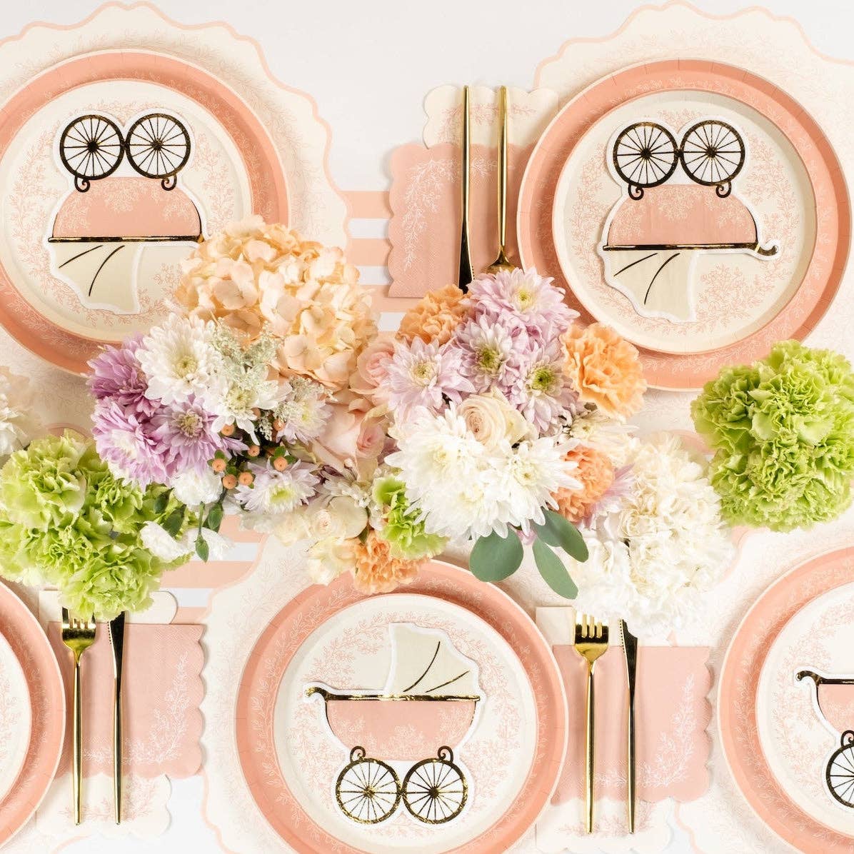 Top view of pink floral plates with pastel table decor