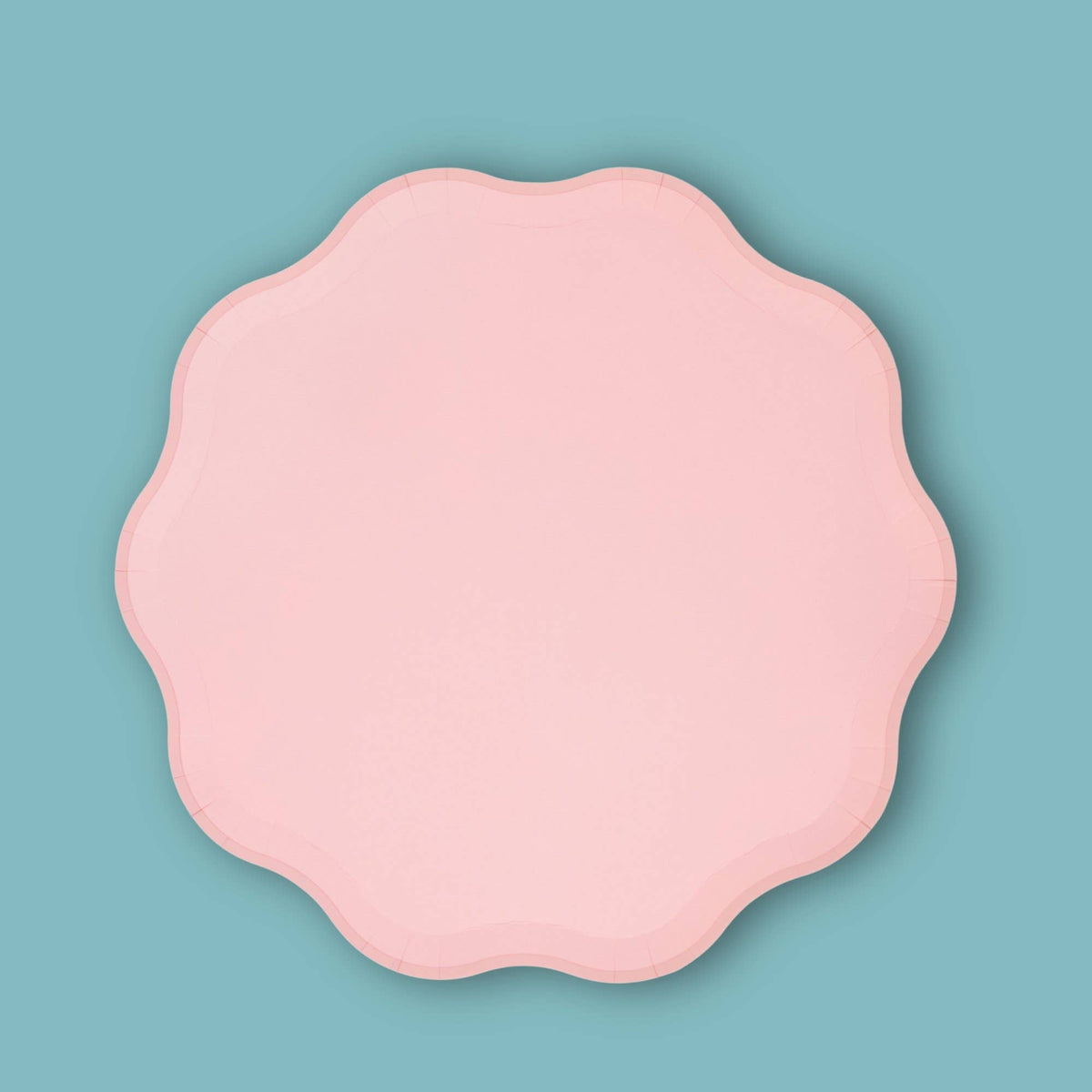 Single pink pastel paper plate with a wavy scalloped edge