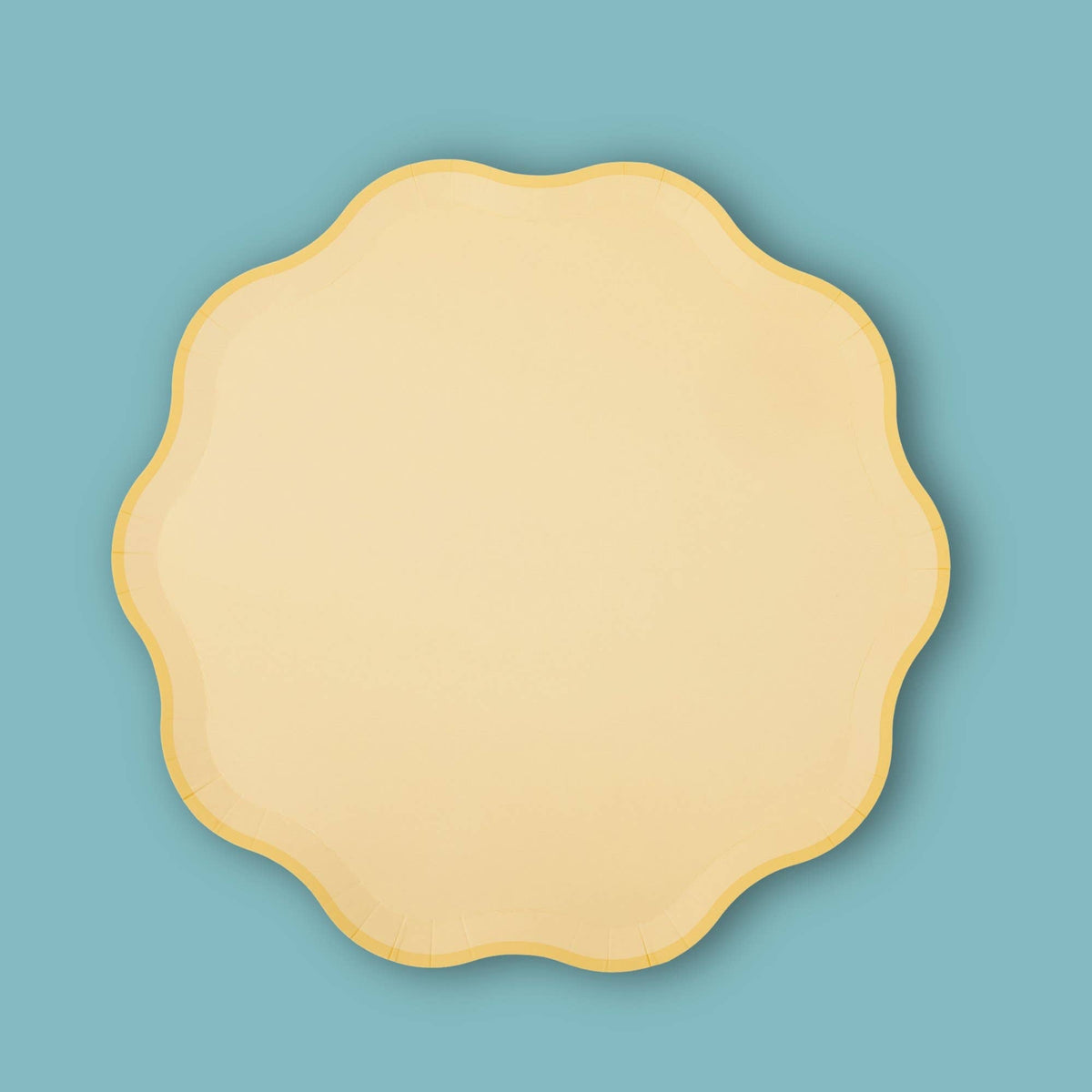 Single butter yellow pastel paper plate with a wavy scalloped edge