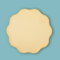 Single butter yellow pastel paper plate with a wavy scalloped edge