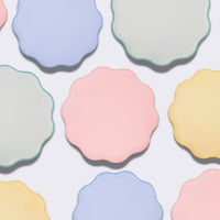Overhead pattern of pastel wavy-edge paper plates in assorted colors
