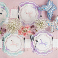 pastel unicorn party table with lavender placemats, flowers, and plates