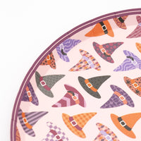 Another close-up angle of the patterned witch hats on the plate with the blush-lavender scalloped edge visible.