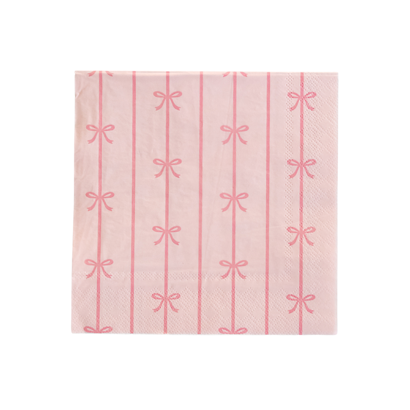 Close-up image of a petal pink paper napkin with vertical bow stripes from the Bonjour Fête Signature Line.