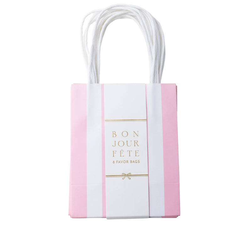 Petal pink cabana stripe paper favor bag with a center label and handles