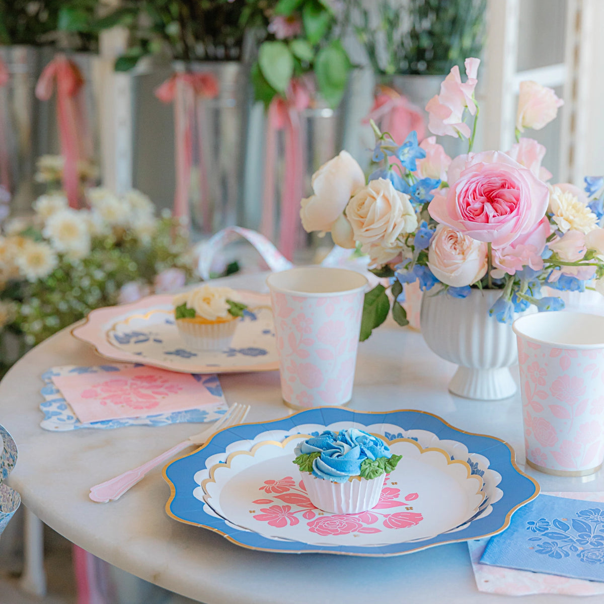 Table setting with Petal Pink floral dessert plate, pink cup, and matching napkins—ideal girl baby shower setup.