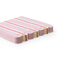 Stack of folded petal pink striped napkins showing the pink stripe and scalloped edge from an angle.