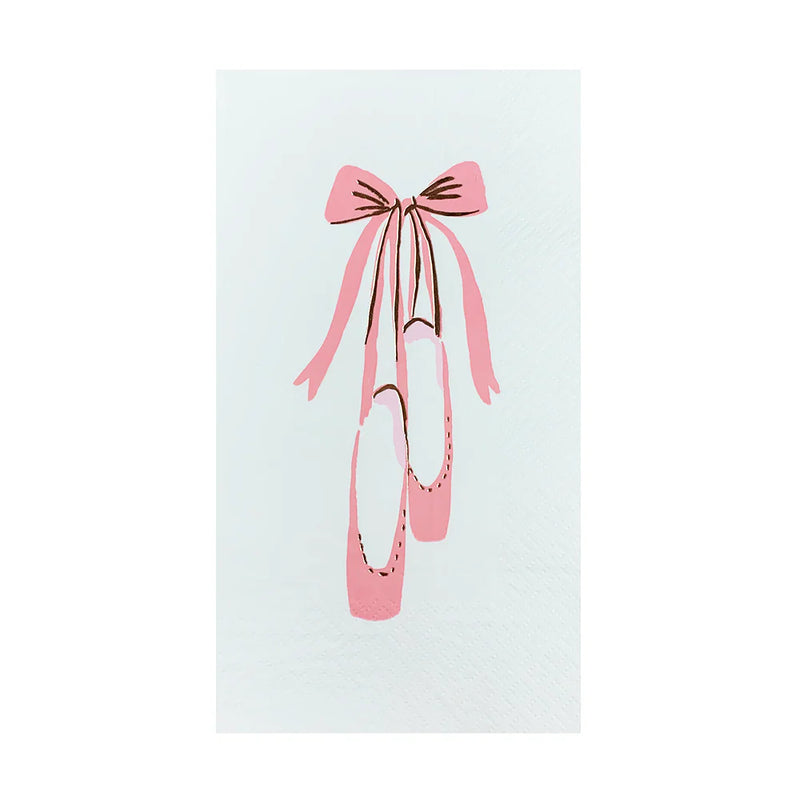 Close-up of a white guest napkin featuring an illustrated pink ballet slipper tied with a ribbon bow.