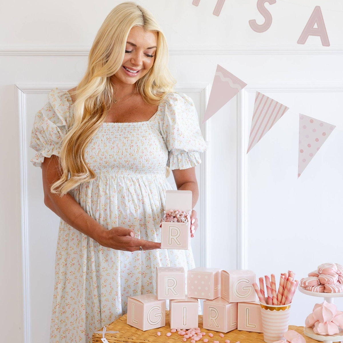 Pregnant mom holding pink block treat box