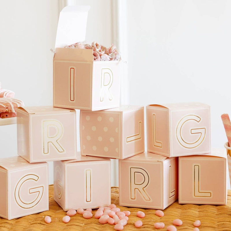 Stacked pink block treat boxes spelling GIRL on baby shower table