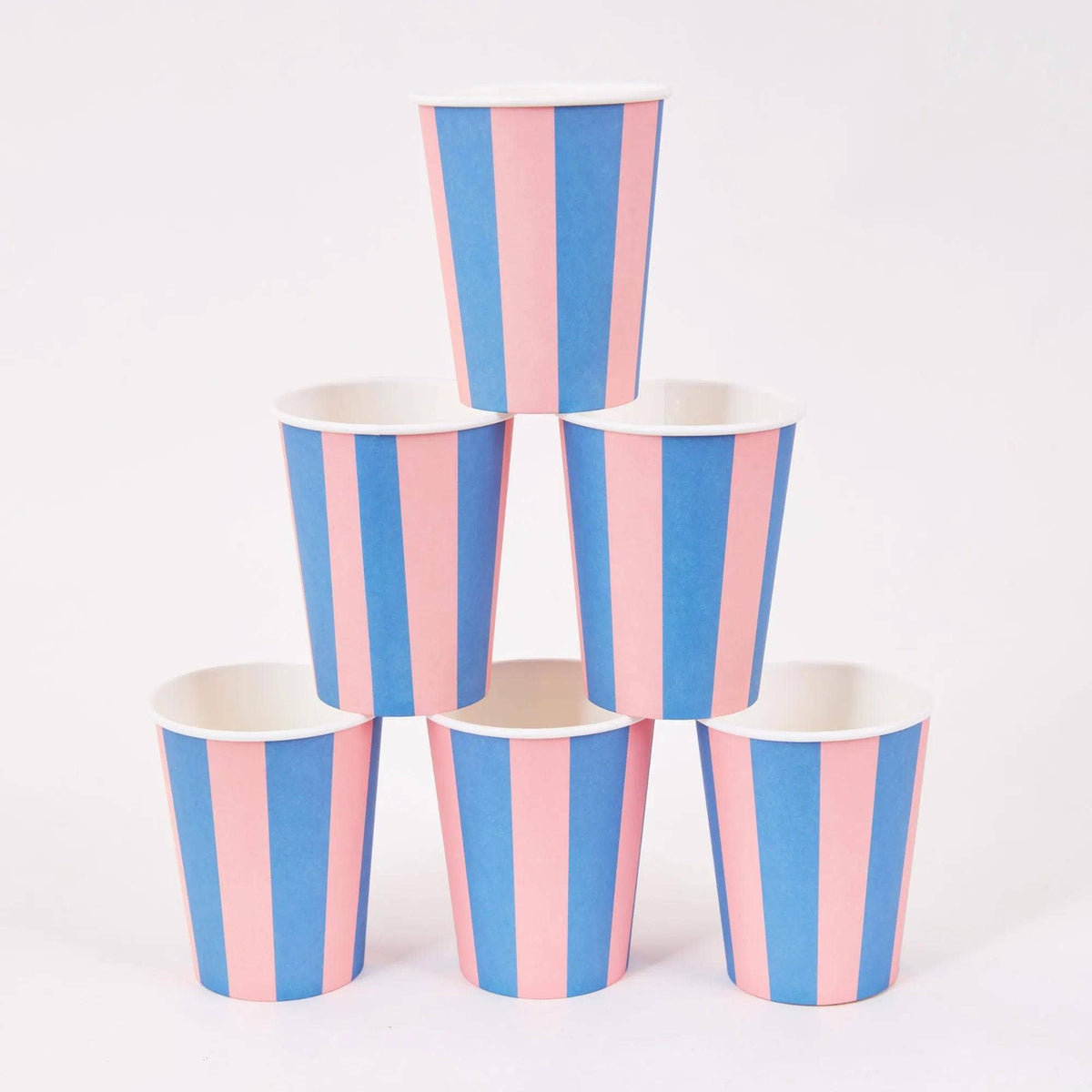 Six pink and blue cabana stripe paper party cups stacked in a pyramid on a white background.