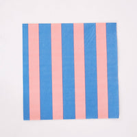 Single pink and blue cabana stripe paper lunch napkin flat on white