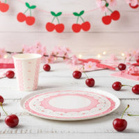 Cherry party cup and dessert plate styled with fresh cherries and a garland