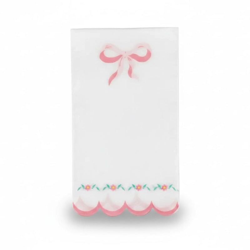 Single white luncheon napkin with a pink bow and scalloped floral edge