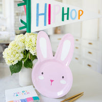 Pink bunny plate styled on Easter table with felt pennant and spring decor.