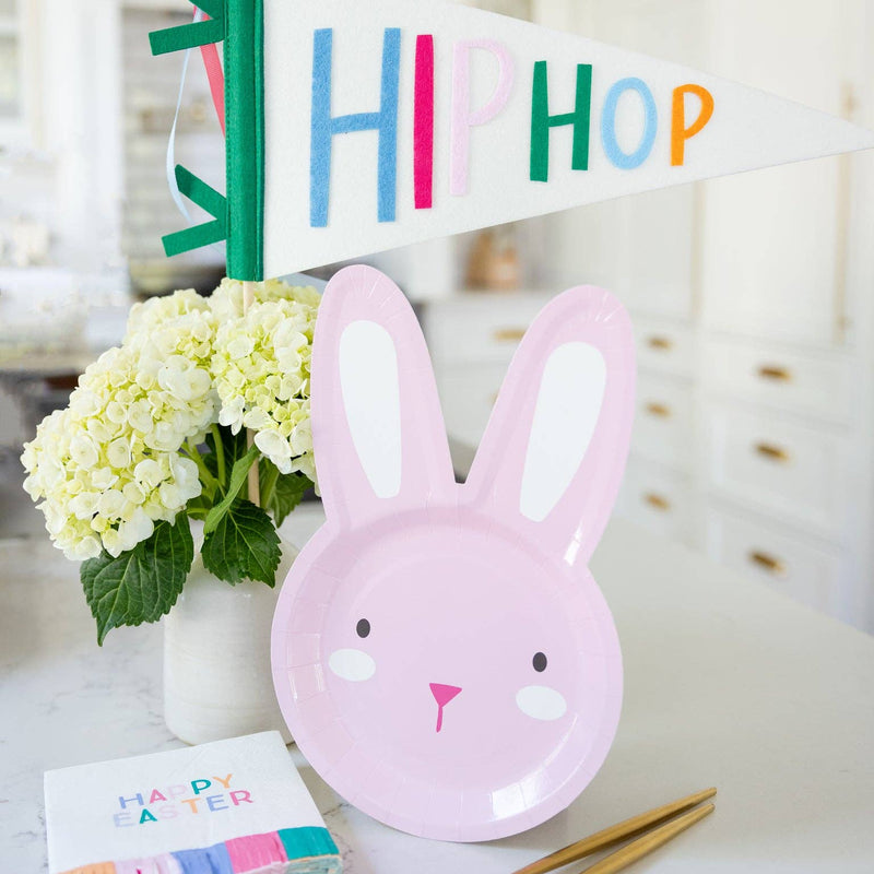 Pink bunny plate styled on Easter table with felt pennant and spring decor.