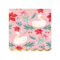 Blush-pink Christmas napkin with an all-over print of white swans, red poinsettias, green sprigs, and tiny red bows, finished with a gold scalloped edge, front view on white background.