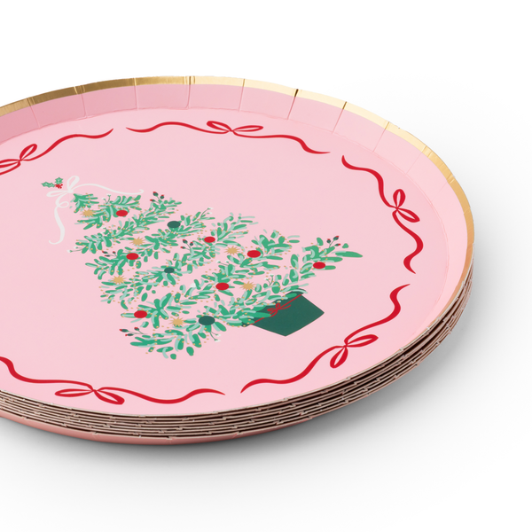 Holiday tablescape featuring Pink Christmas Tree dessert plates layered over plaid dinner plates with festive ribbon décor.