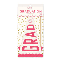 Packaging for a pink felt graduation pennant featuring a wooden dowel and grosgrain ribbons.