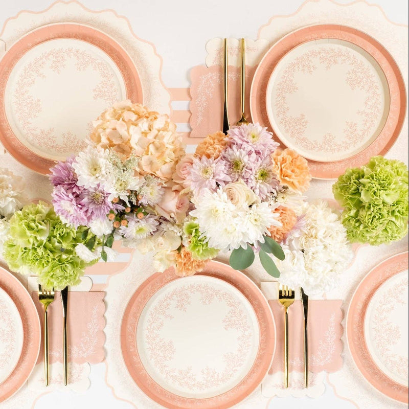 Pink floral napkins styled with plates and spring flowers table setting