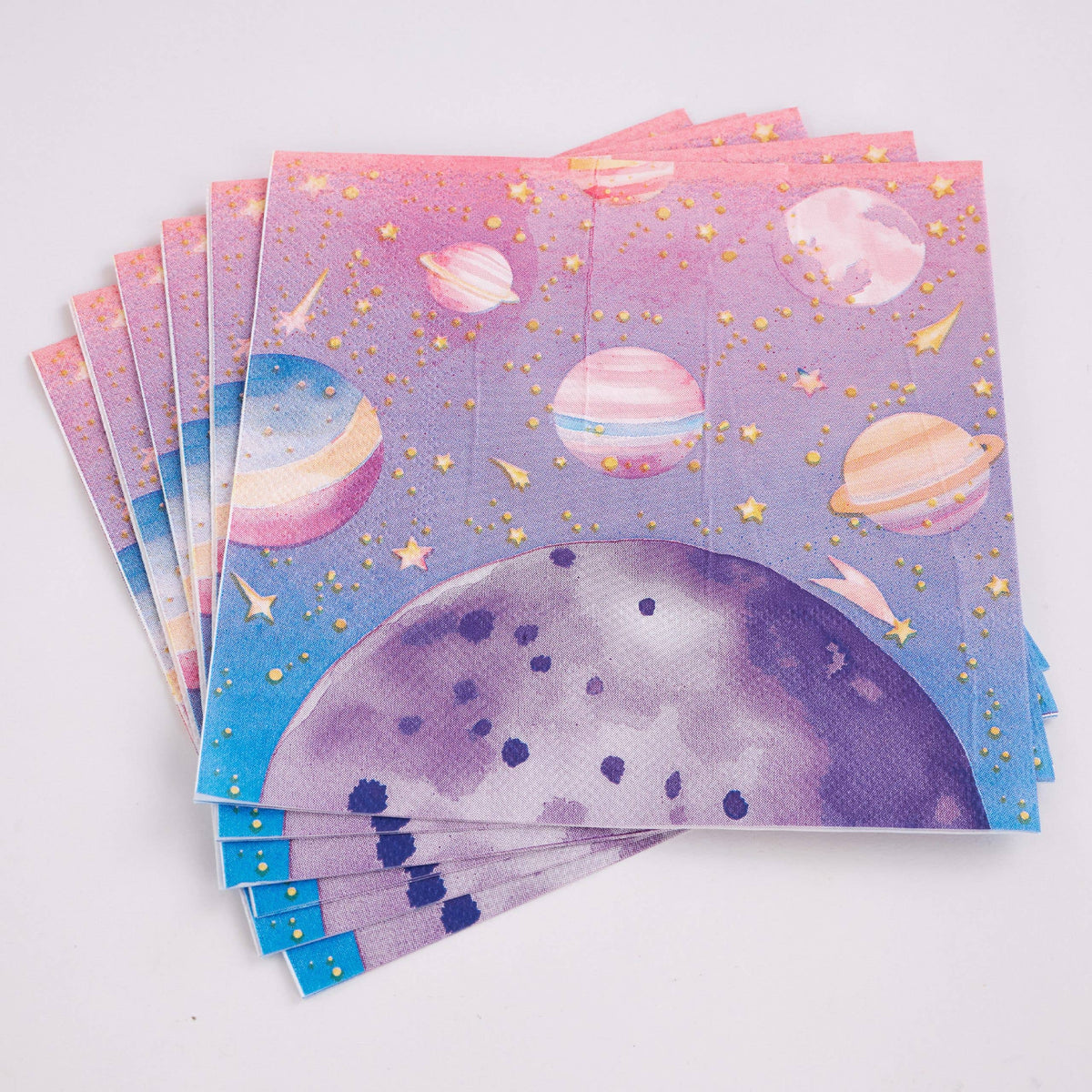 Fanned stack of folded pink galaxy paper lunch napkins