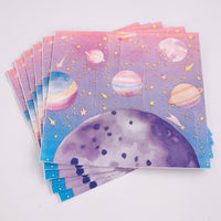 Fanned stack of folded pink galaxy paper lunch napkins