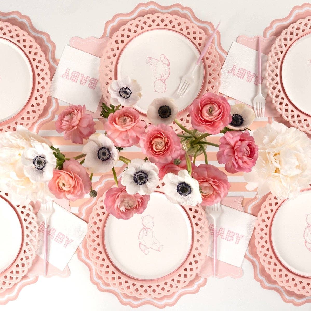 Overhead girl baby shower tablescape with pink gingham BABY cocktail napkins at each seat and pink ranunculus