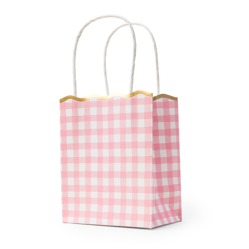 Pink gingham paper favor bag with gold scalloped rim and twisted white handles, standing upright