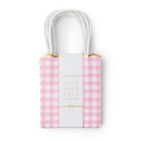 Set of 8 pink gingham paper favor bags stacked with a gold foil band reading 8 favor bags