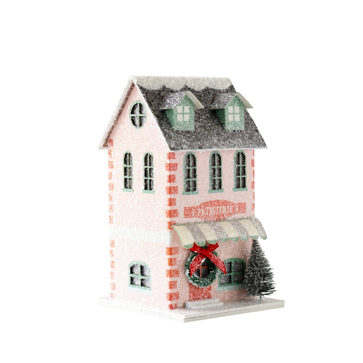 Angled view of the pink patisserie house on white showing the round attic window and side wall