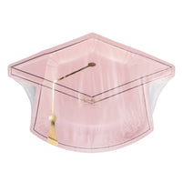 Pink graduation cap shaped plate in packaging with gold tassel design