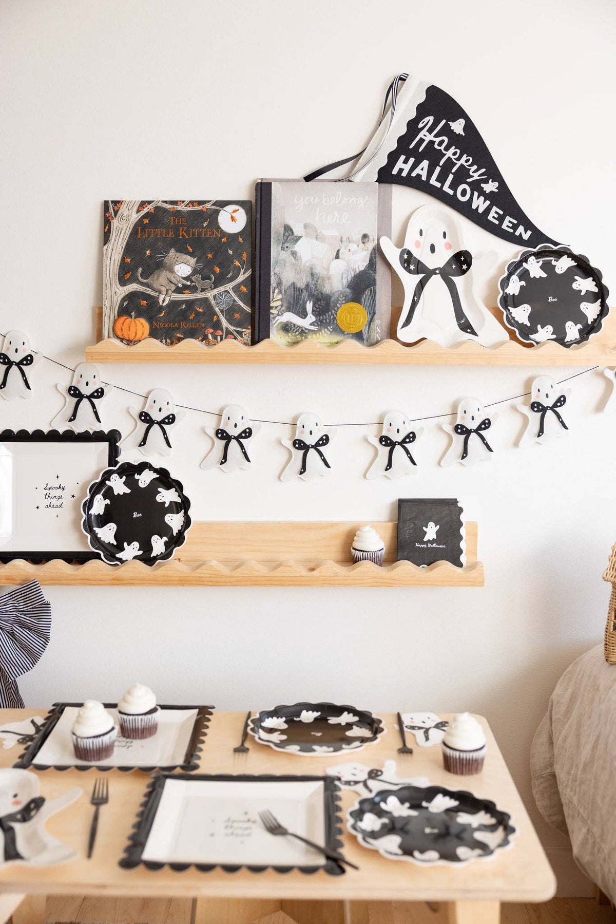 Happy Halloween felt banner hung in a black & white Halloween tablescape.