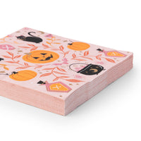 Angled stack of pink witchy Halloween paper napkins with black cats and pumpkins