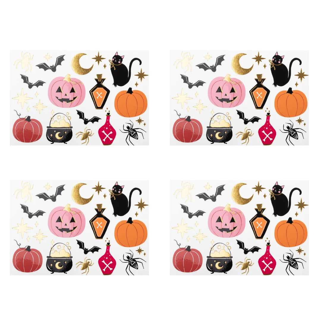 Pink Halloween paper napkin scattered with pink orange and red pumpkins, a black cat, bats, spiders, a cauldron, potion bottles, and gold moon and stars.