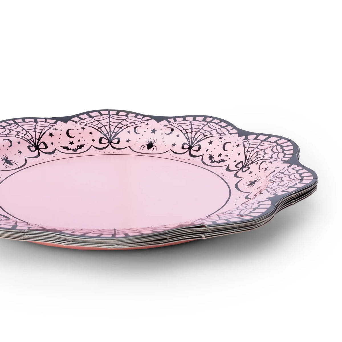 Stack of pink lace-border Halloween plates showing the scalloped edge and spiderweb design.