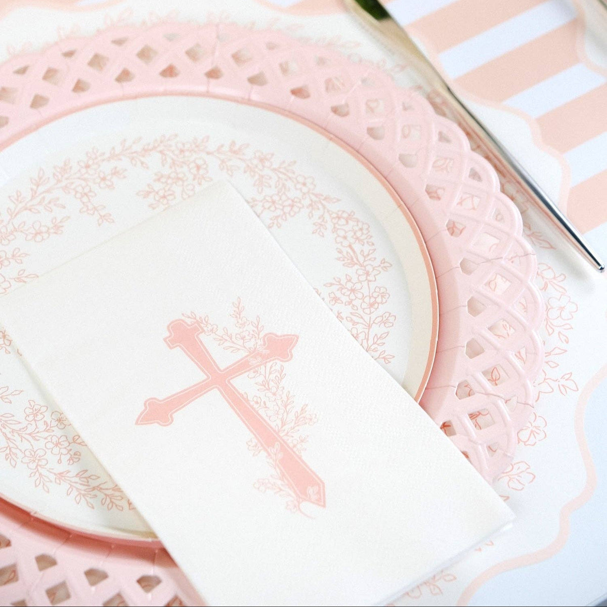 A detailed view of the delicate lattice work on the rim of a pink heirloom aesthetic paper plate.