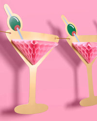 Two pink martini glass banner pieces shown at angle with shadows against pink background