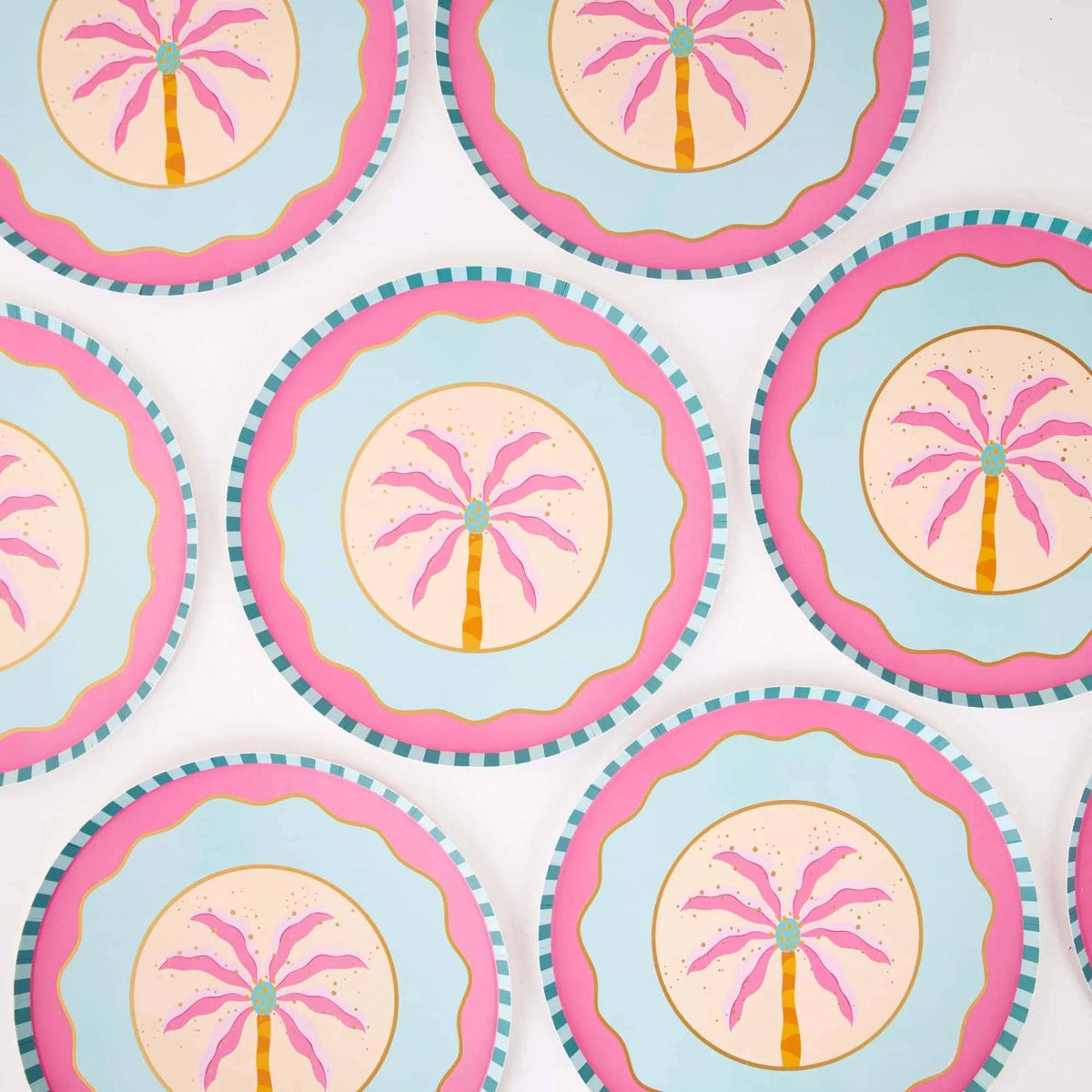 Repeating pattern of pink palm tree dessert plates showing the boho palm design and pink scallop.