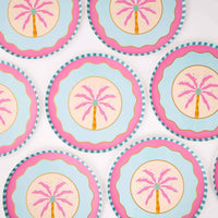Repeating pattern of pink palm tree dessert plates showing the boho palm design and pink scallop.