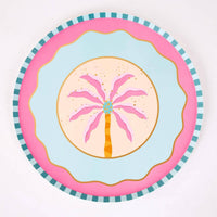 Single pink palm tree paper dessert plate with a hot-pink palm, sand center, pink wave scallop, and teal striped rim.
