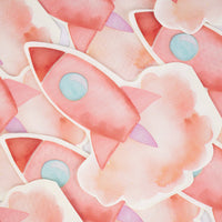 Close-up scatter of pink rocketship die-cut paper napkins