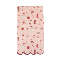 Pink dinner napkin with Santa, gifts, and candy cane pattern and scalloped red edge
