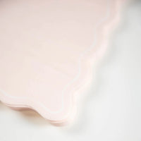Close detail of scalloped edge on blush guest towel.