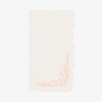 Single ivory guest towel with a scalloped edge and pink floral corner spray