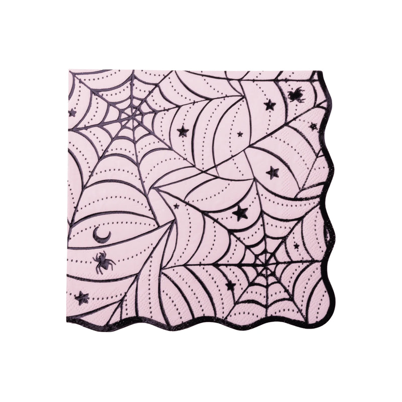 Pink Halloween napkin with a black spiderweb print, stars, a moon, and a spider, finished with a wavy edge.